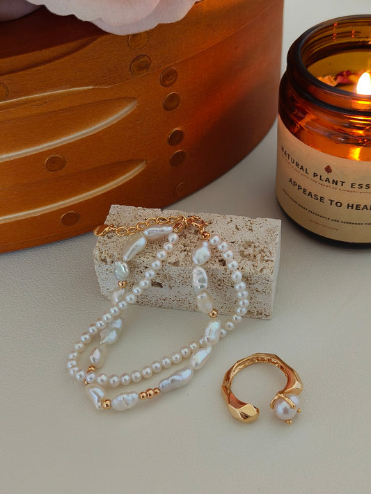 Pearl bracelet with gold-tone accents, baroque pearls, and toggle clasp
