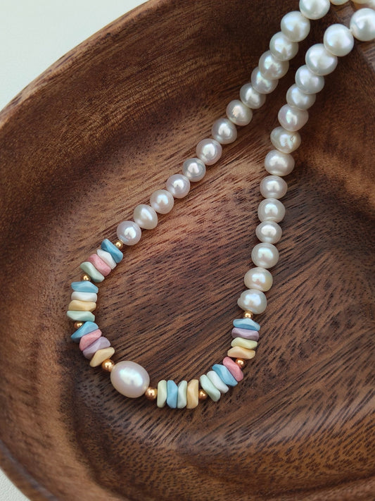 Freshwater pearl necklace with rainbow stone bead spacer links along the strands.