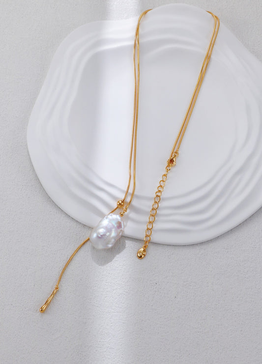 Gold adjustable baroque pearl pendant necklace with thin chain and tassel end