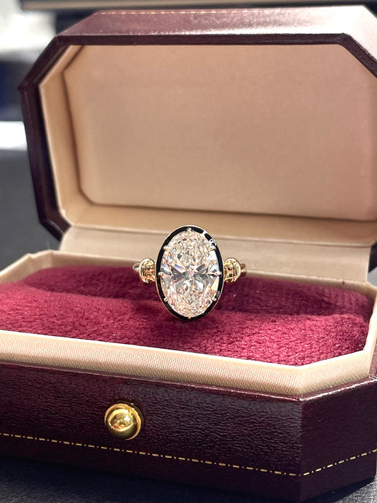 Oval lab diamond ring with yellow gold-tone band and dark halo setting