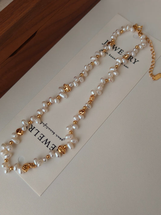 Freshwater pearl necklace shown on a jewelry card with gold-tone heart charm
