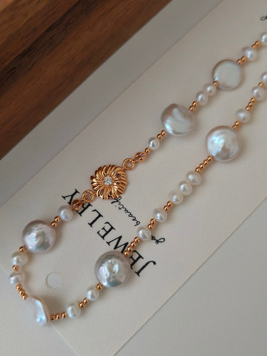 Freshwater pearl necklace with gold-tone floral charm and pearl bead strands