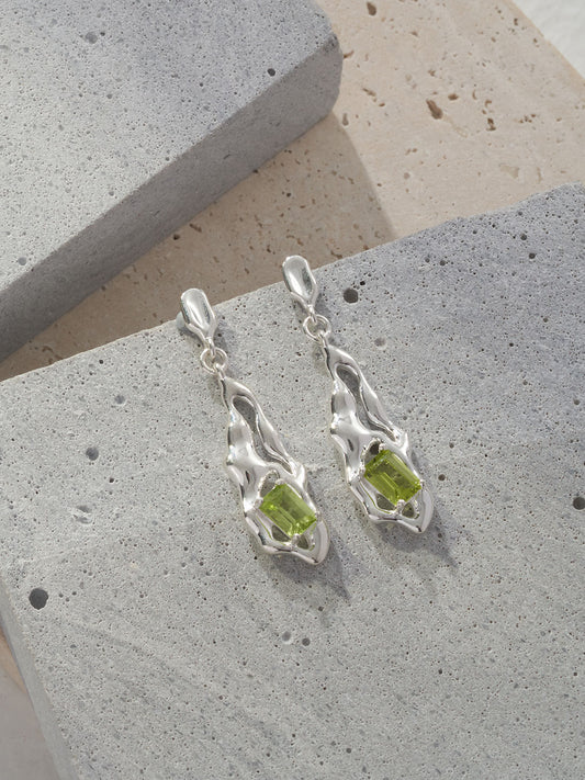 Peridot green gemstone drop earrings with textured silver wavy settings, close-up