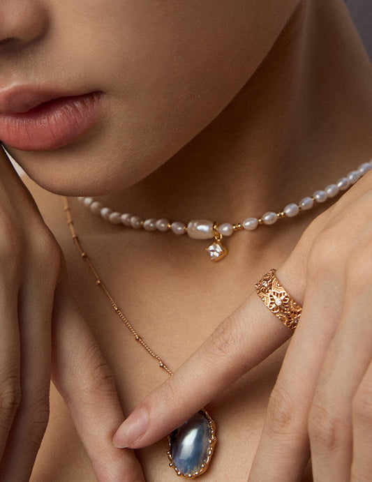 Mabe pearl pendant necklace on model with oval blue pearl and delicate gold chain