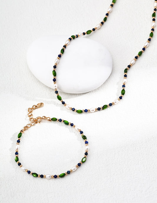 Bead pearl necklace with green and navy bead pattern and gold-tone chain, clasp visible