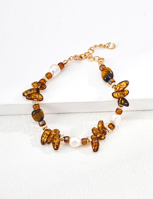 Gold-tone bracelet with amber tiger eye beads and white pearl accents