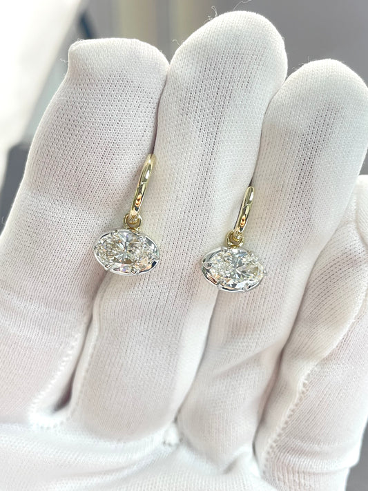 Gold-tone drop earrings with clear crystal teardrop and small halo stones