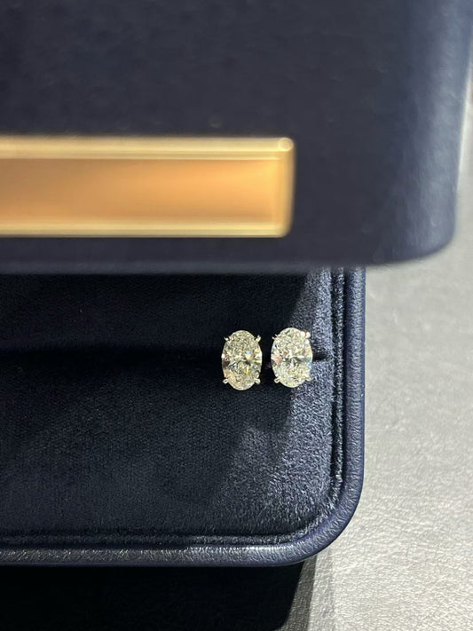 Oval lab diamond stud earrings, gold-tone settings with bright oval stones