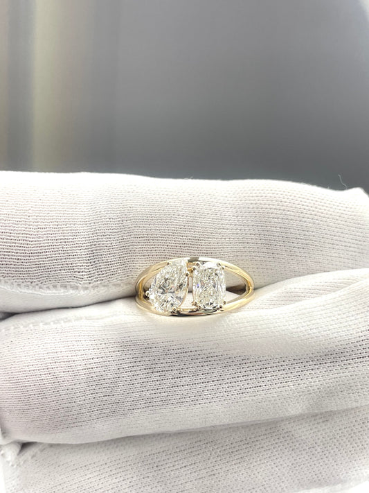 Gold lab diamond ring with oval center stone and halo, close-up