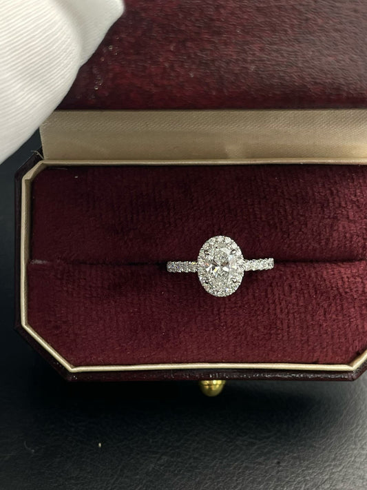 Oval lab diamond halo ring with oval center stone and side diamonds, ring box view
