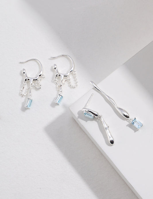 Silver-tone drop earrings with blue square gemstones and curved lever hooks