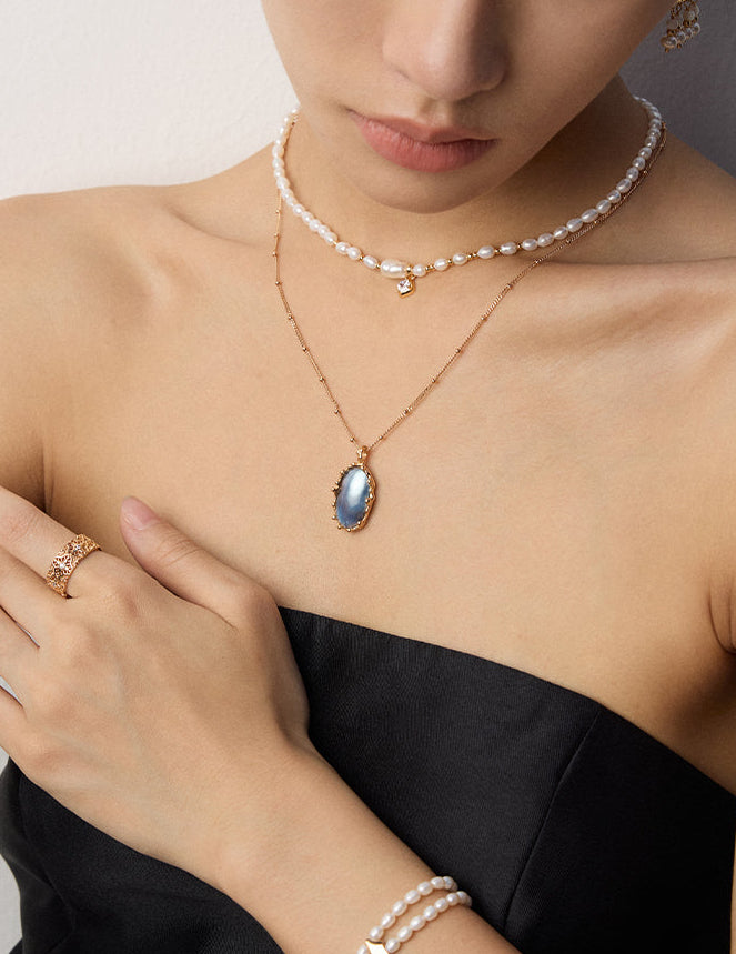 Mabe pearl pendant necklace on model with oval blue mabe pearl pendant