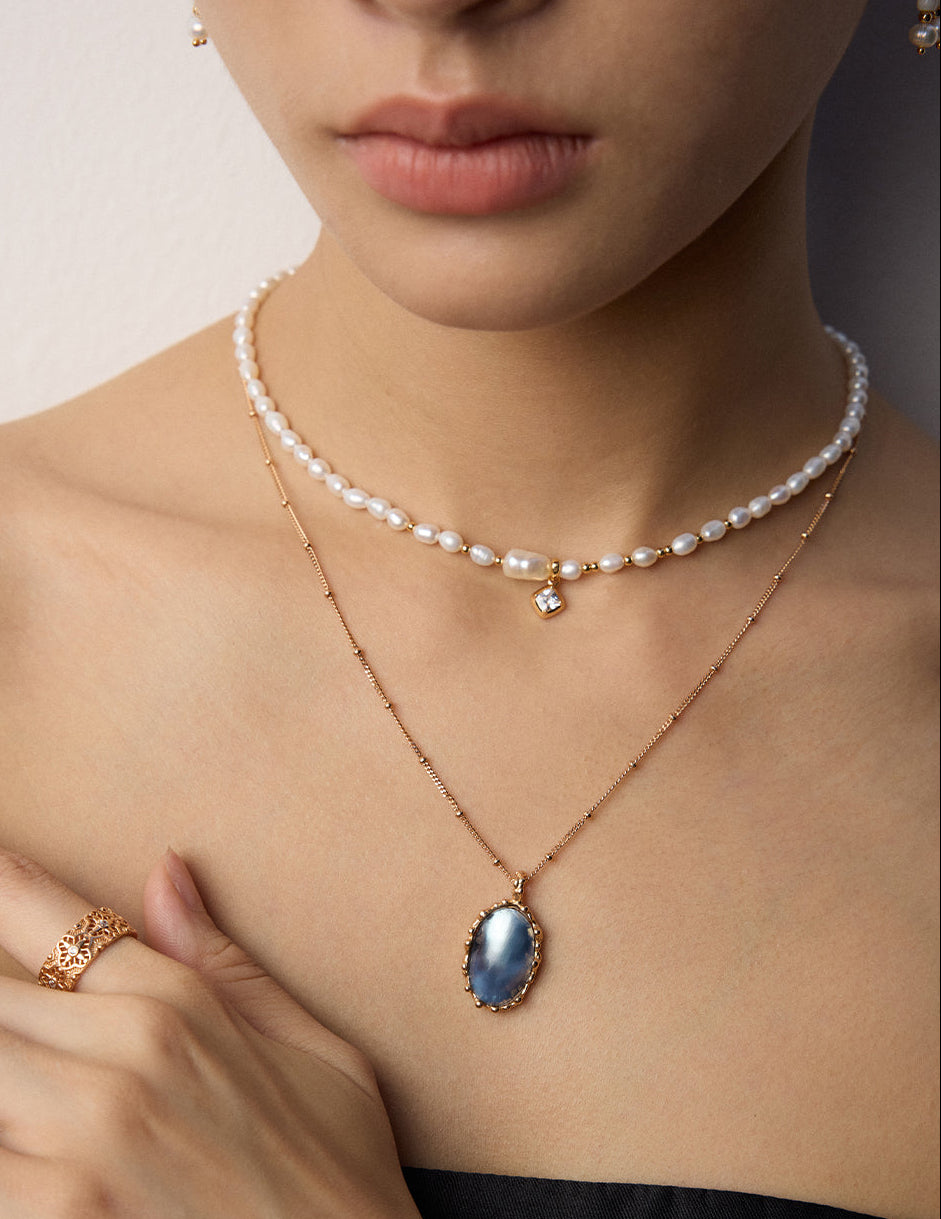 Mabe pearl pendant necklace worn close-up with oval blue pearl pendant