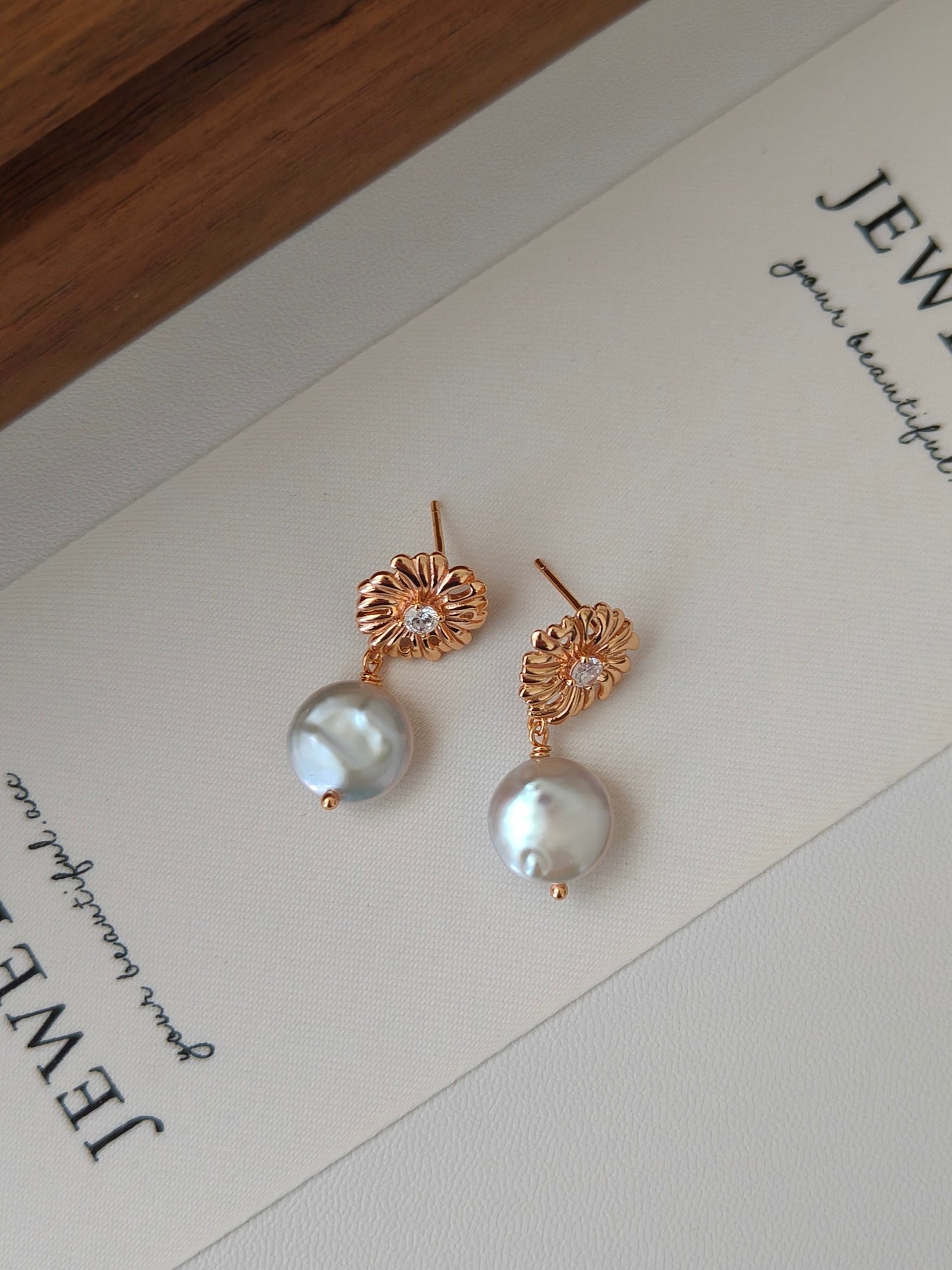 Gold-tone floral stud pearl drop earrings with round iridescent white pearls
