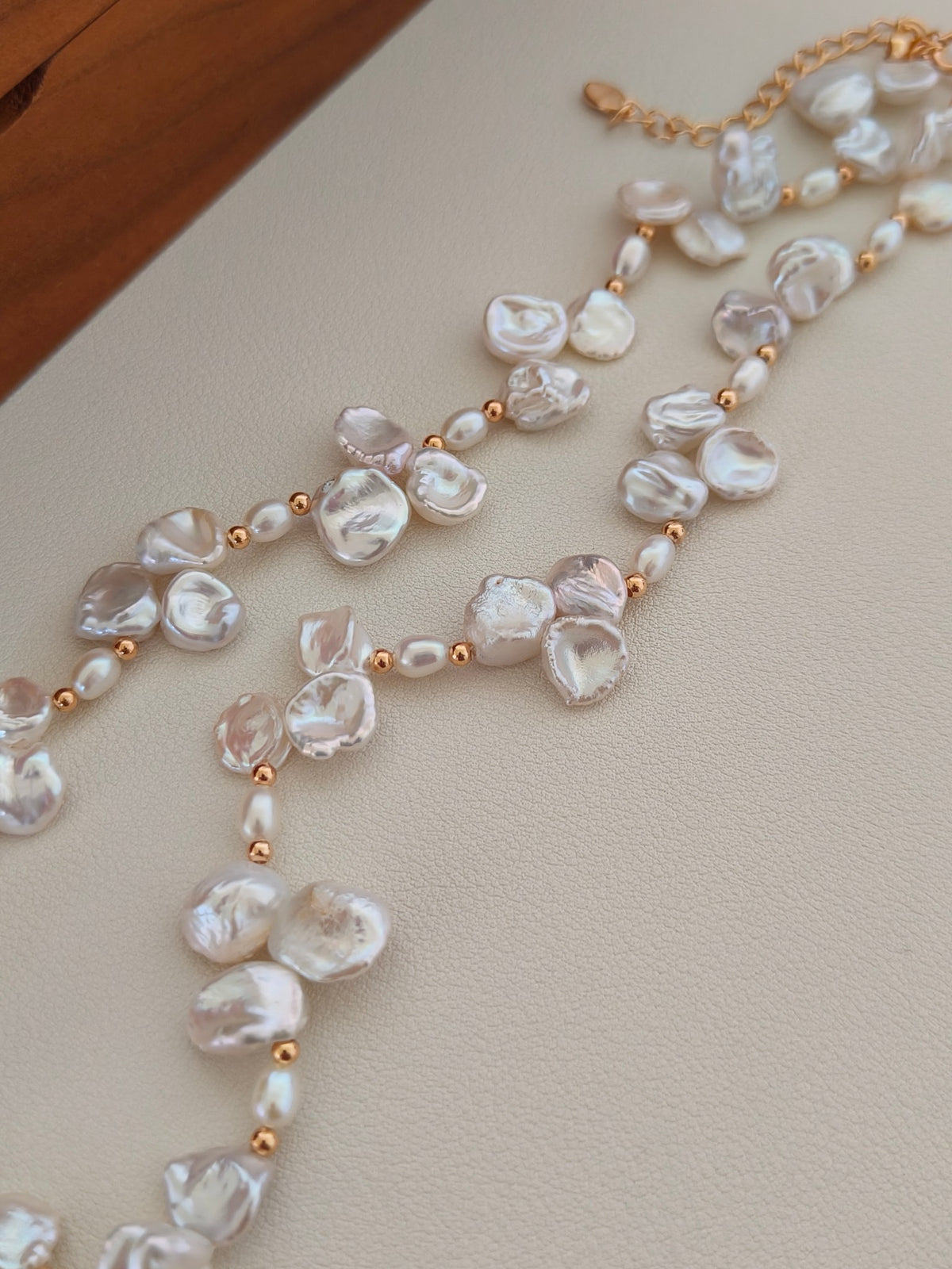 Freshwater pearl necklace close-up with gold-tone beads between baroque pearls
