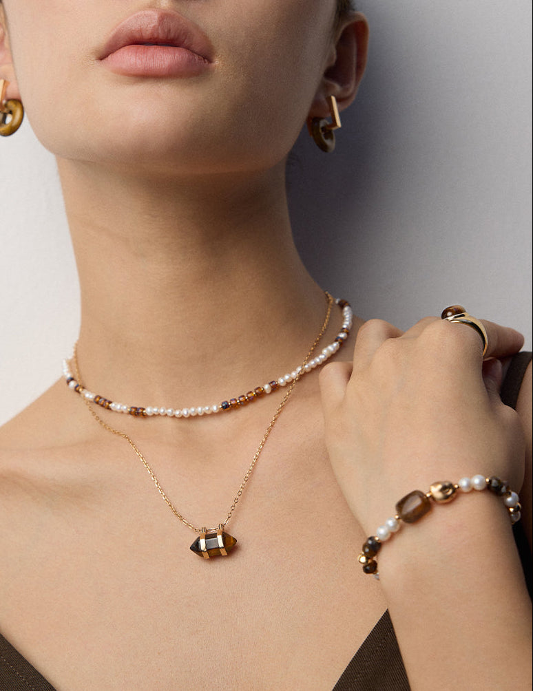Pearl bead necklace with gold geometric pendant charm on a delicate chain