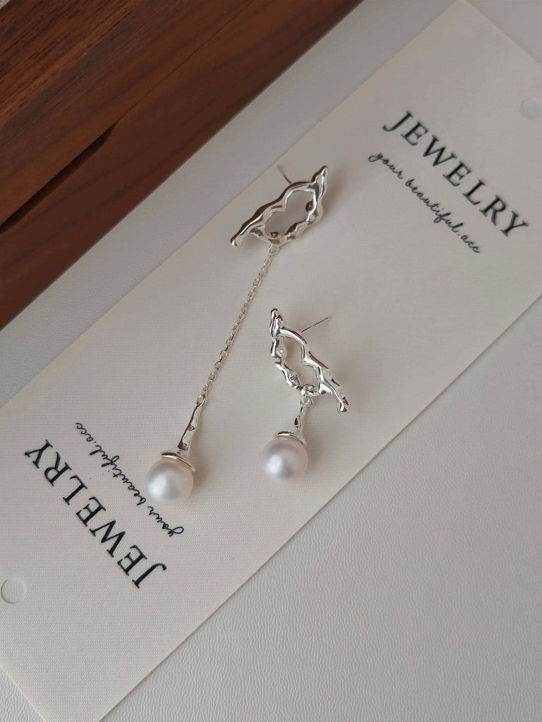 Tui in flight pearl earrings with silver bird charms and dangling white pearls