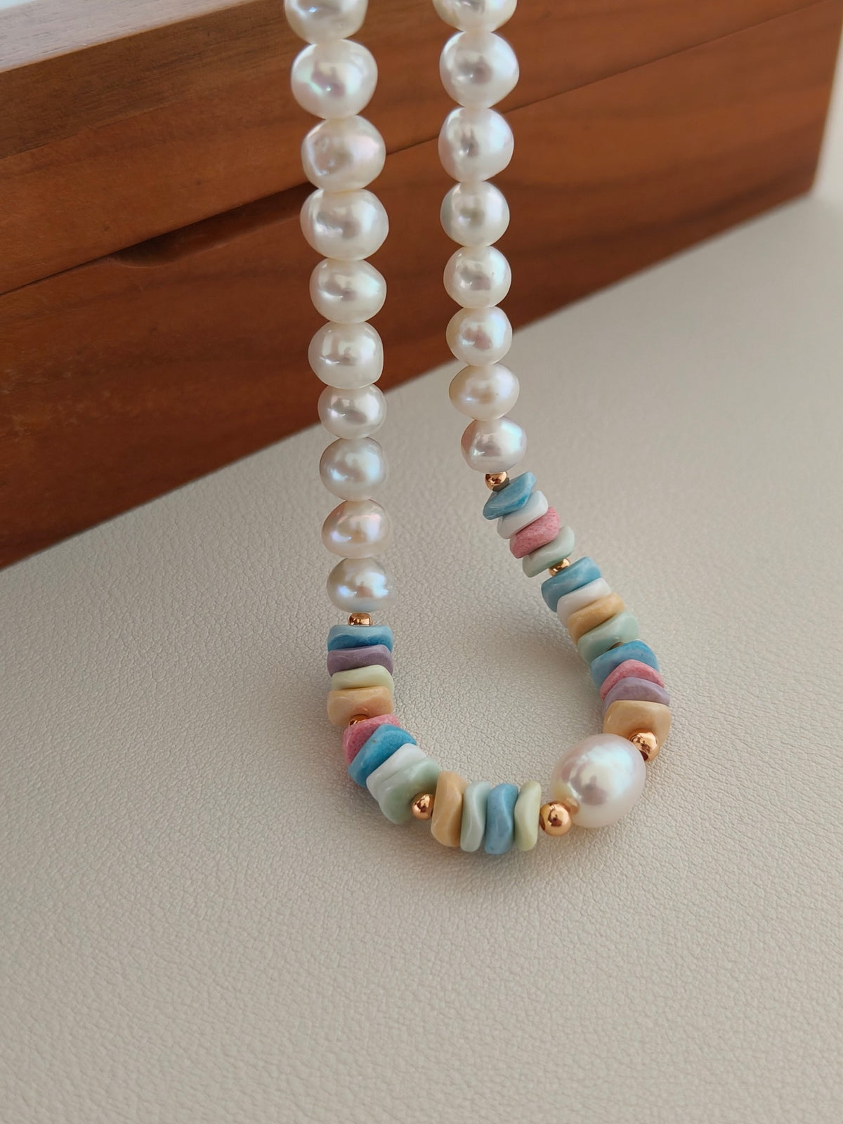 Freshwater pearl necklace featuring pastel rainbow stone beads between pearls.