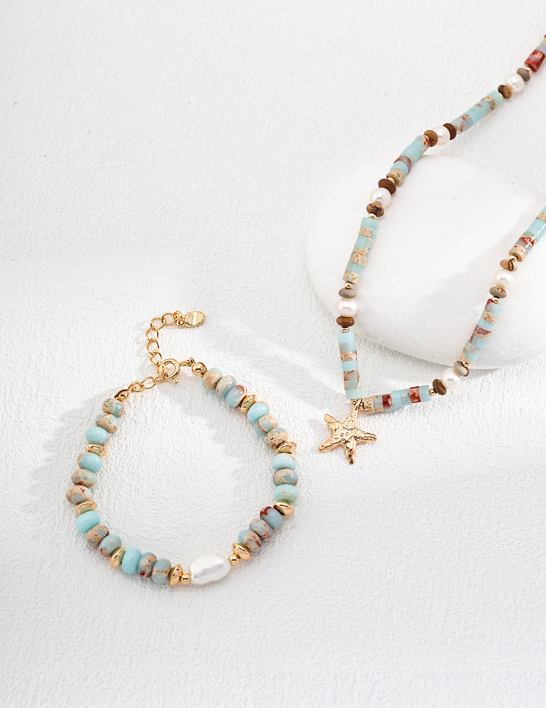 Gold-tone beaded bracelet with turquoise beads, multicolor accents, and small cross star charm