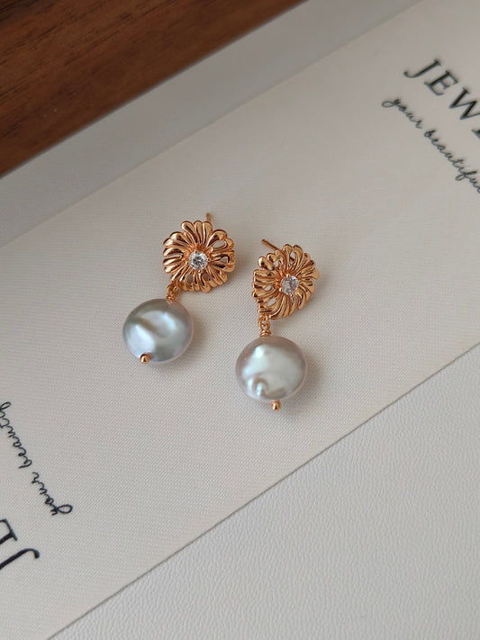 Rose-gold floral stud earrings with crystal centers and iridescent pearl drops