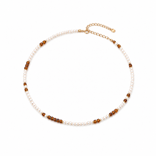 Pearl and amber bead necklace with gold clasp and small dark bead accents