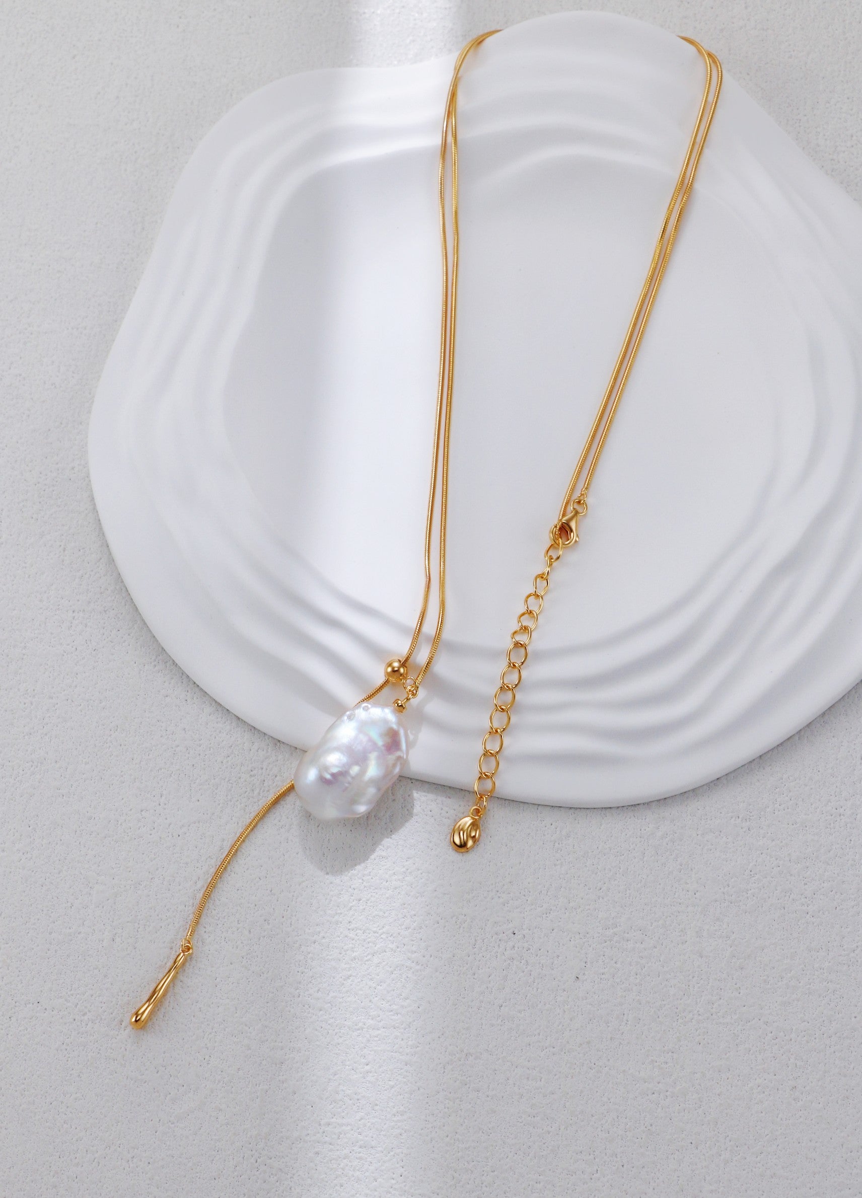 Gold adjustable baroque pearl pendant necklace with thin chain and tassel end