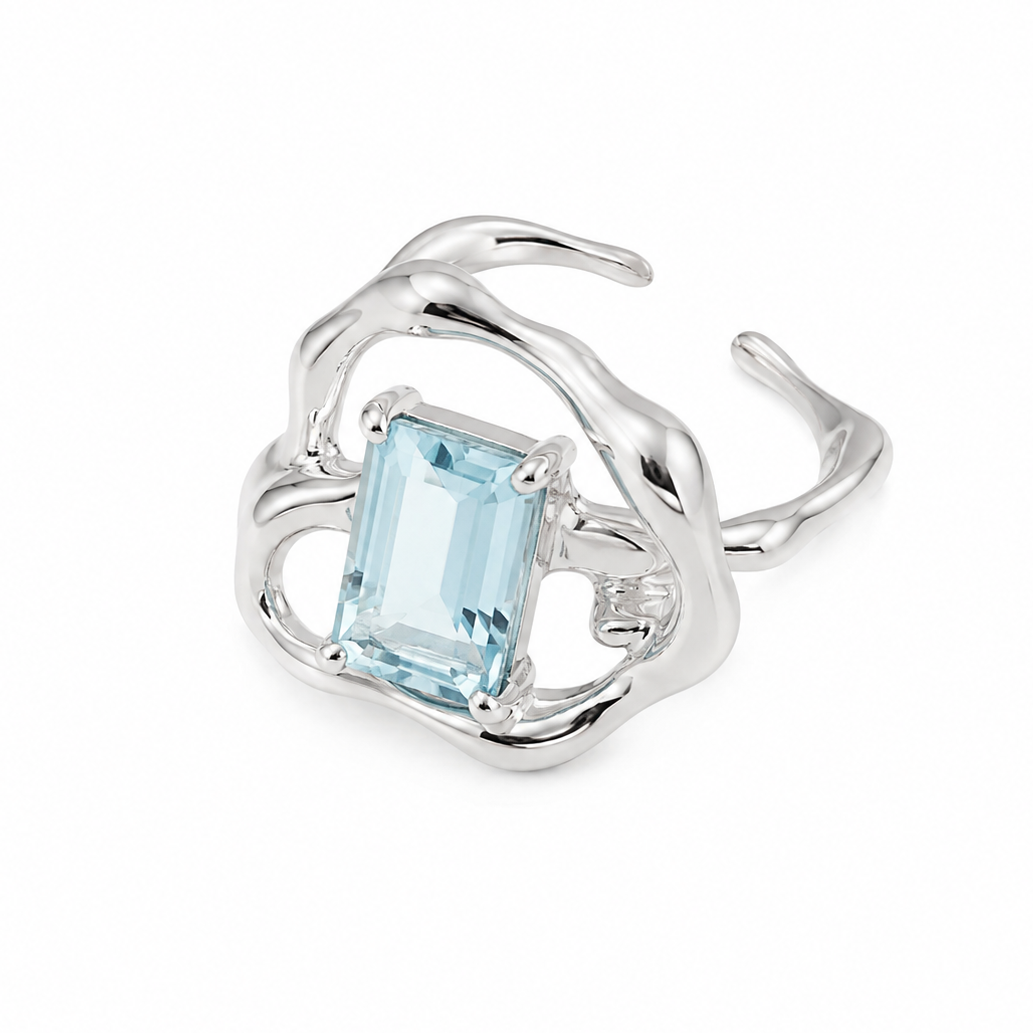 Silver ring with rectangular light-blue gemstone in a flowing openwork band