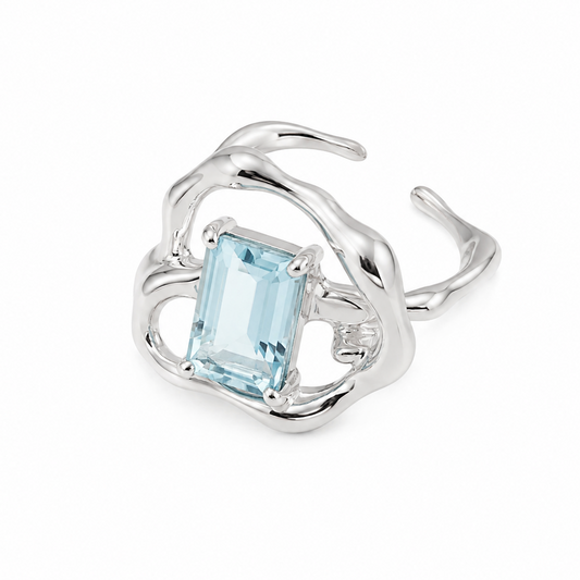 Silver ring with rectangular light-blue gemstone in a flowing openwork band