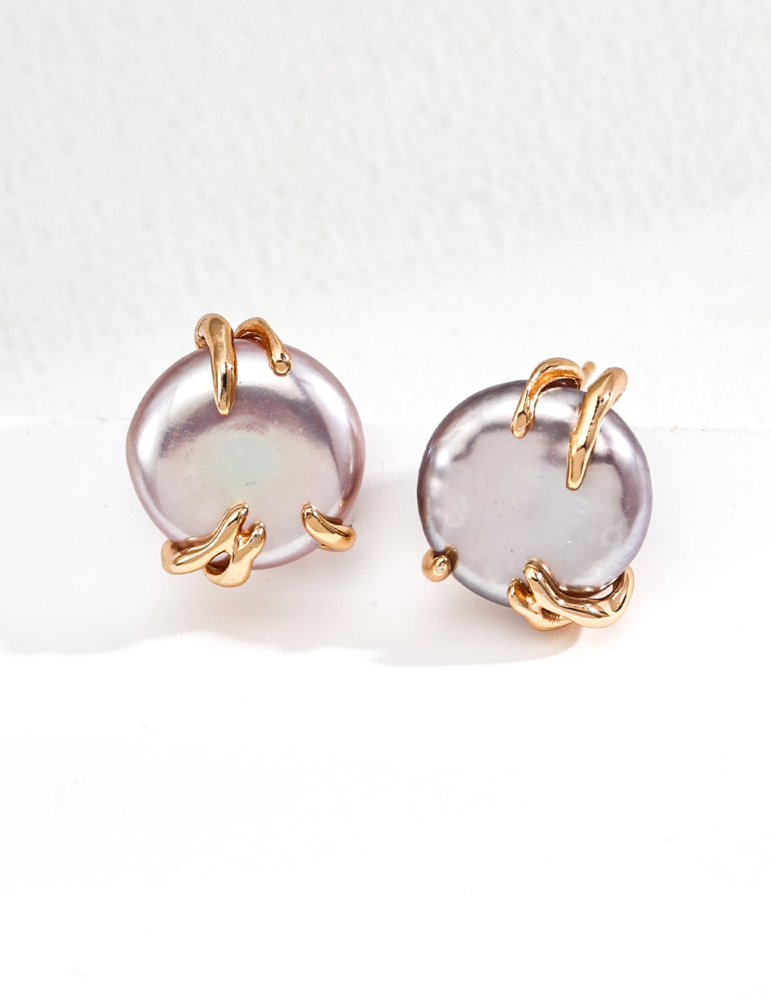 Purple Edison pearl hoop earrings with gold-tone hinges, side angle