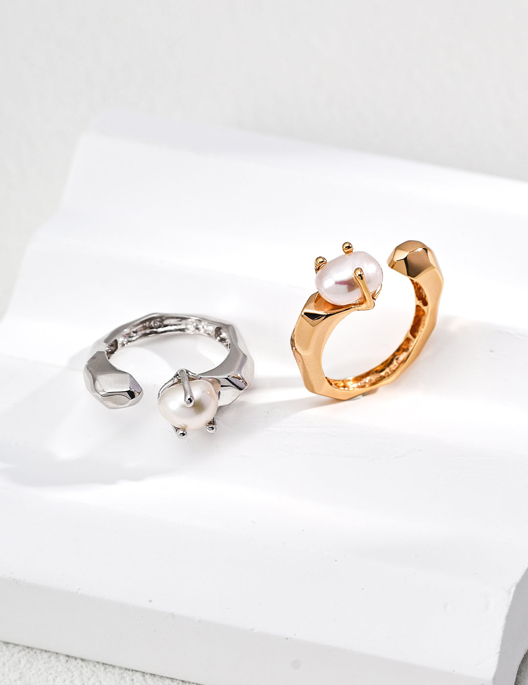 Pair of baroque pearl open rings in gold and silver tones