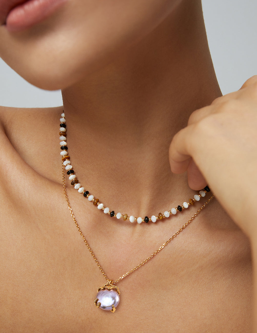 Layered pearl bead necklace with lavender Edison pearl pendant in gold-tone setting