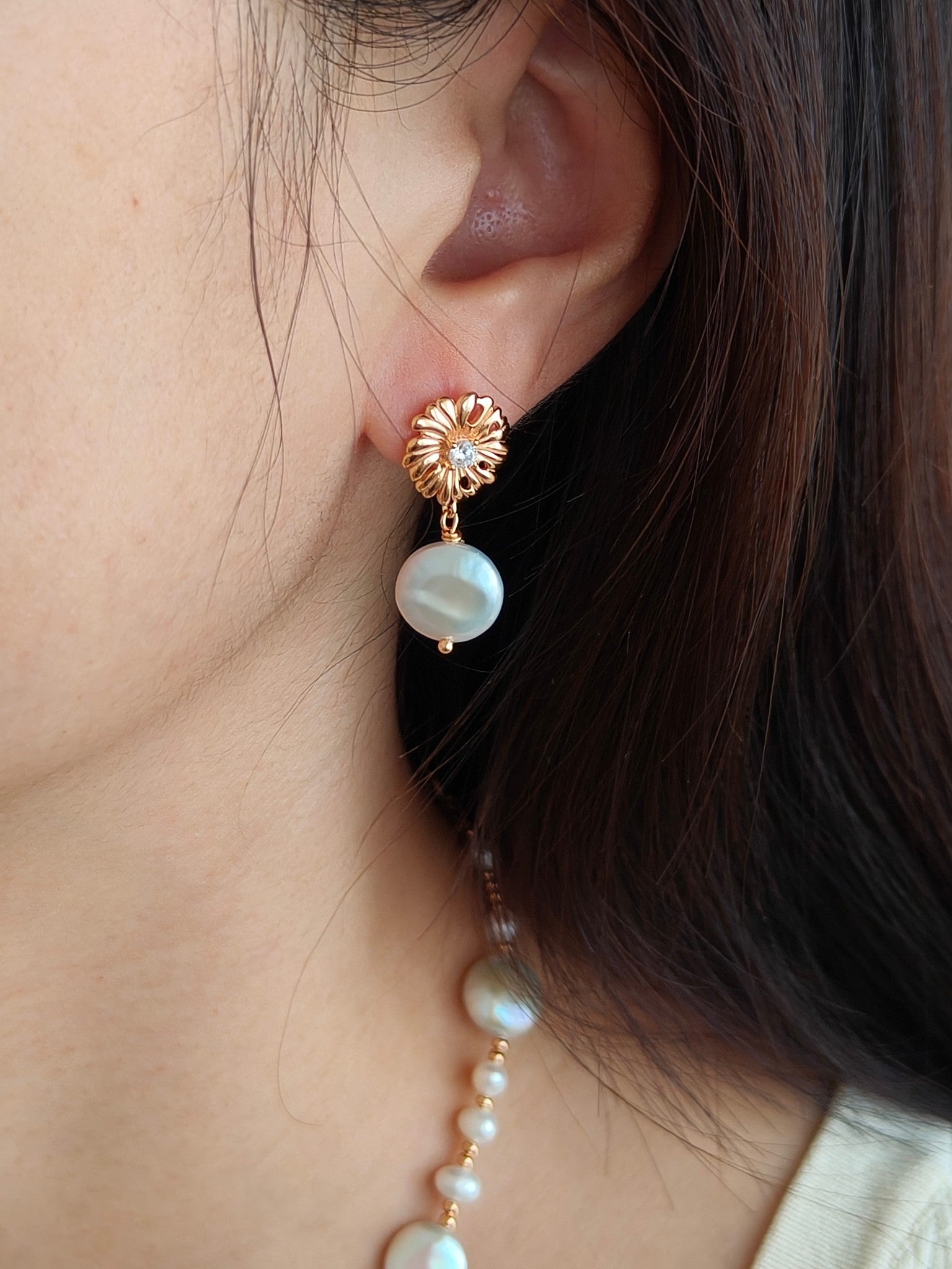 Gold-tone floral pearl drop earrings with crystal center and round white pearl