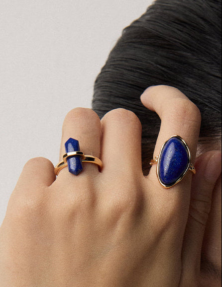 Gold open cuff ring with oval blue lapis lazuli cabochon and matching stones