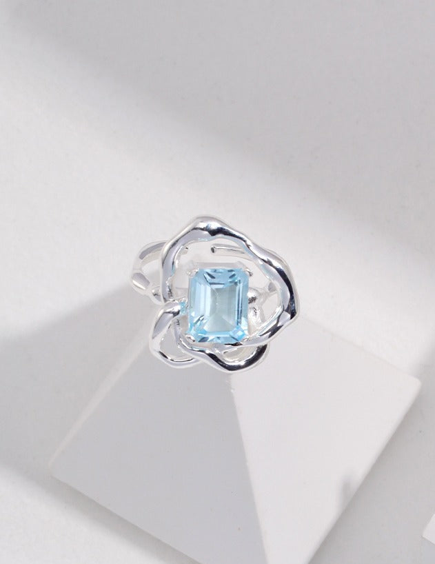 Silver ring with light-blue rectangular gemstone, shown front view