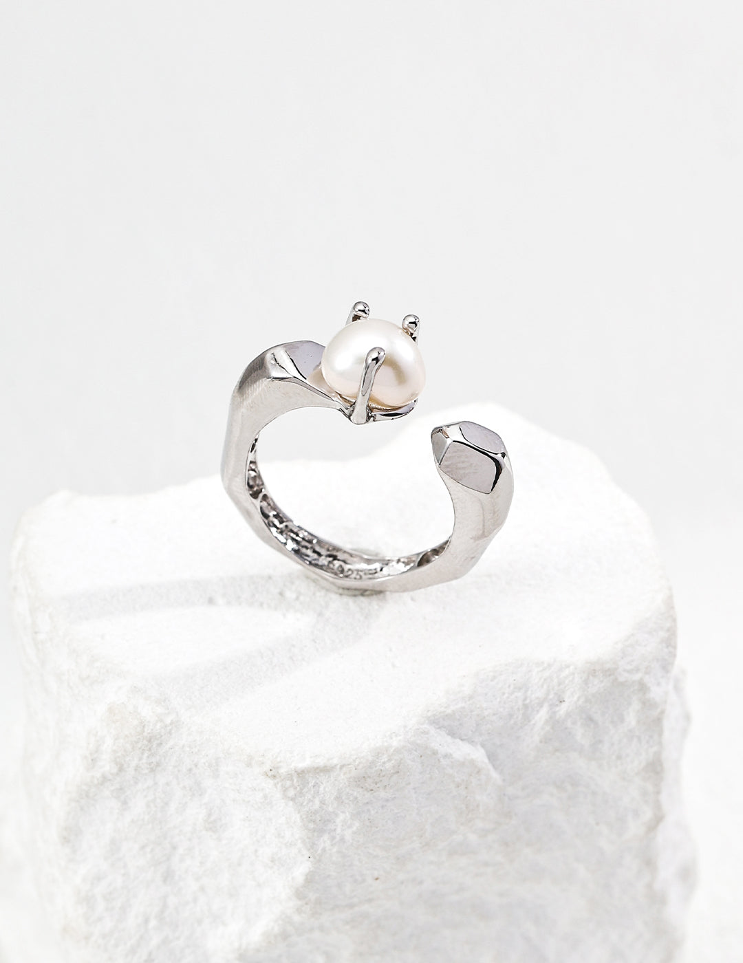 Silver-tone baroque pearl open ring with sculpted band and small pearl centerpiece