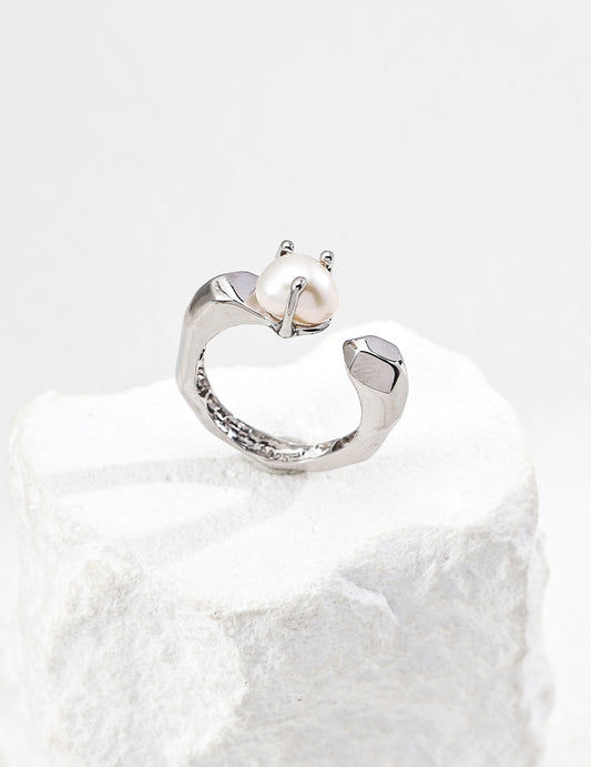 Silver-tone baroque pearl open ring with sculpted band and small pearl centerpiece