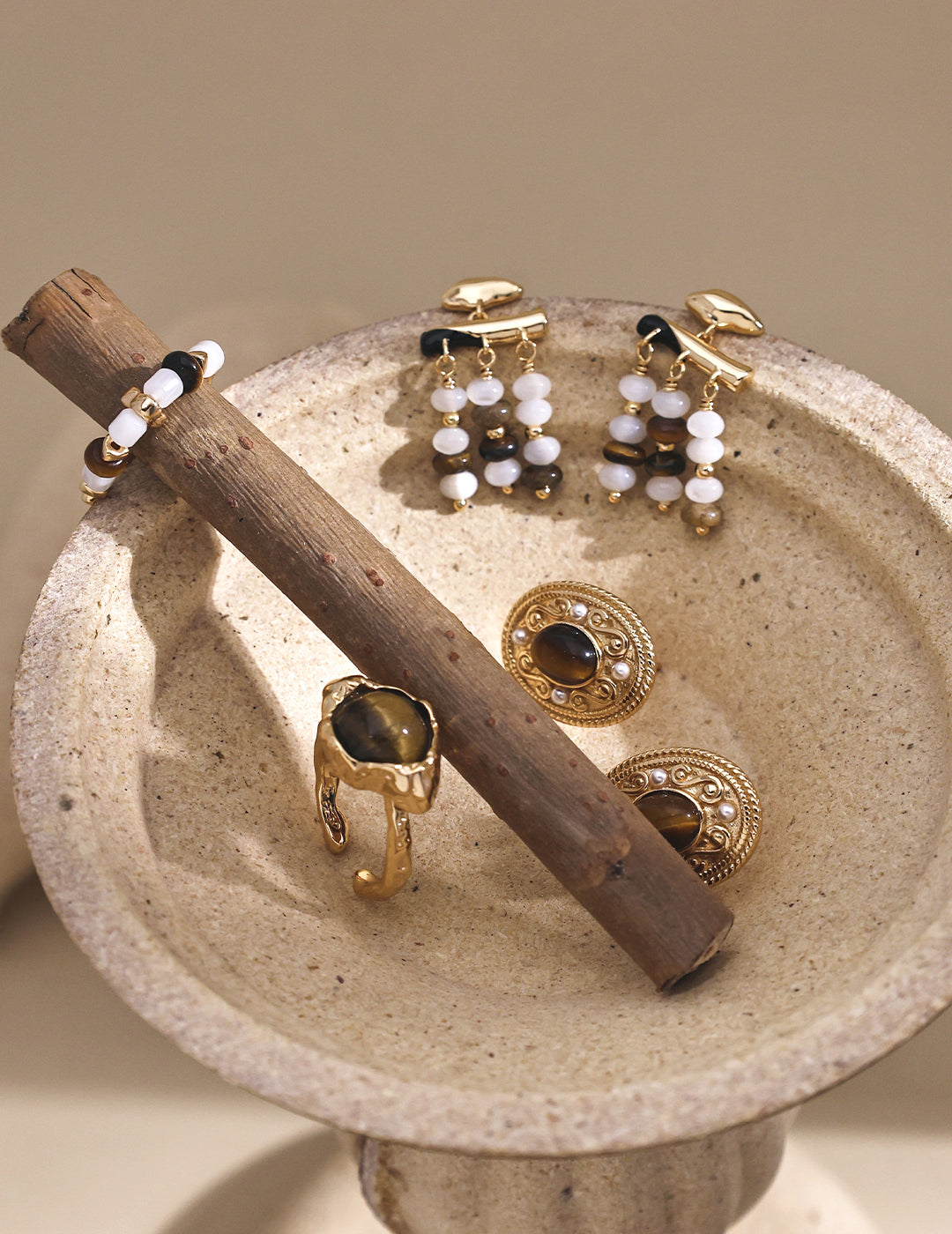 Gold-tone hoop earrings with white pearls and tiger eye bead drops
