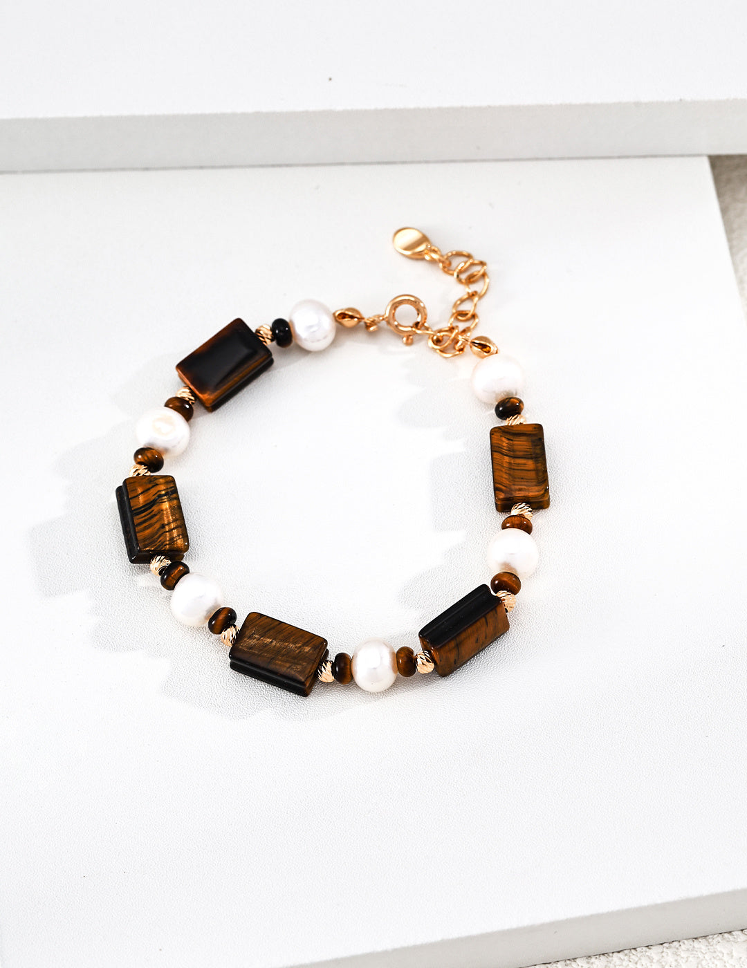 Tiger eye and white pearl beaded bracelet with gold-tone chain and clasp