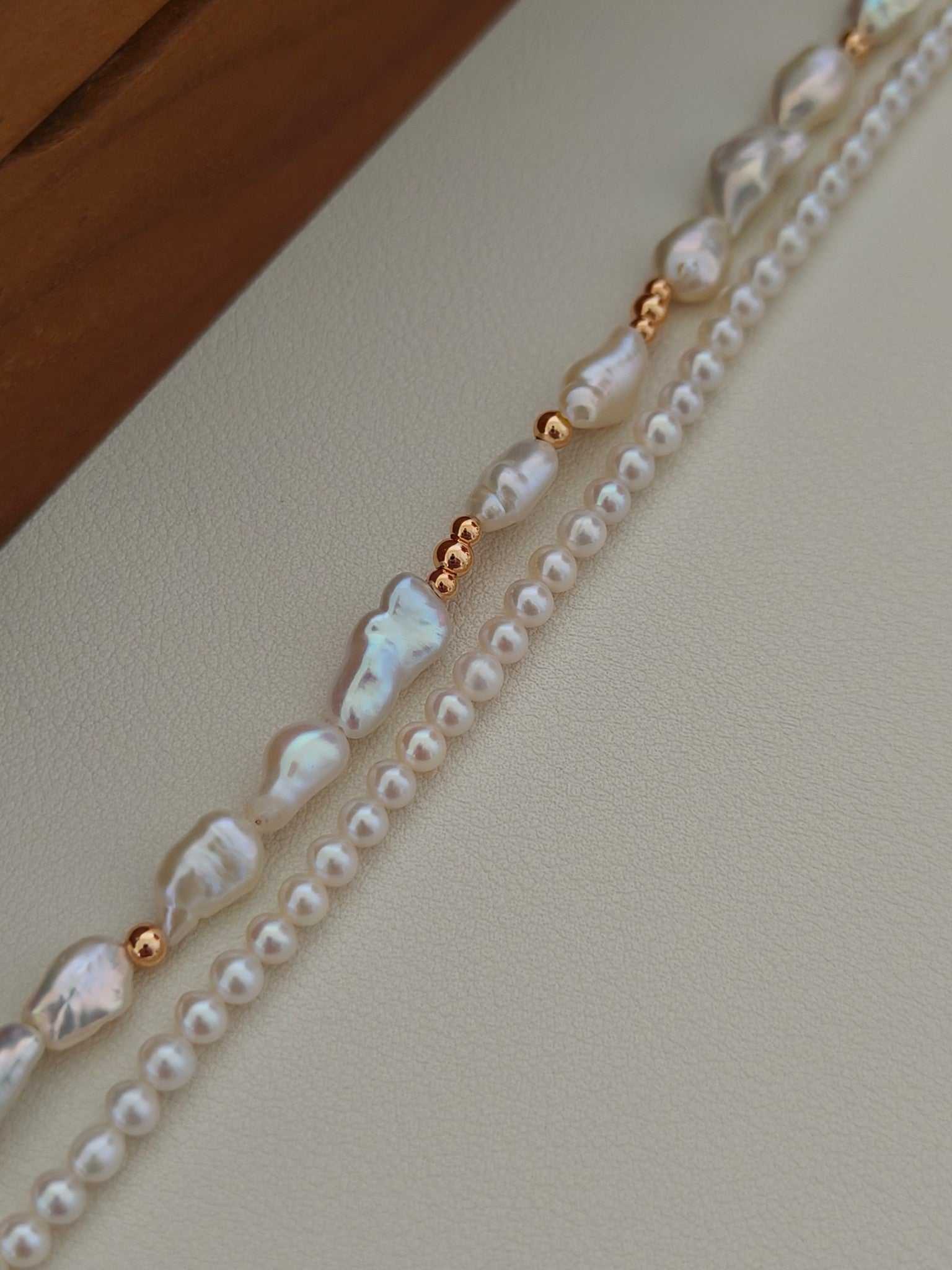 Close-up double-layer freshwater pearl bracelet with baroque pearls and gold beads