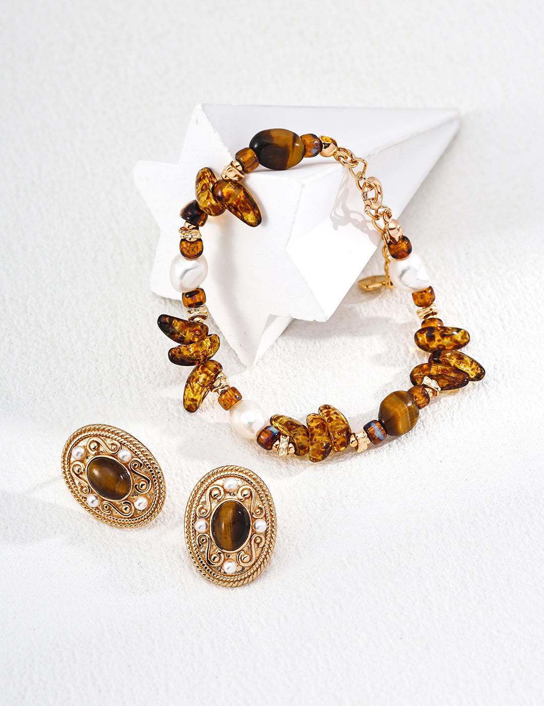 Gold-tone beaded bracelet with amber tiger eye chips and white pearl beads