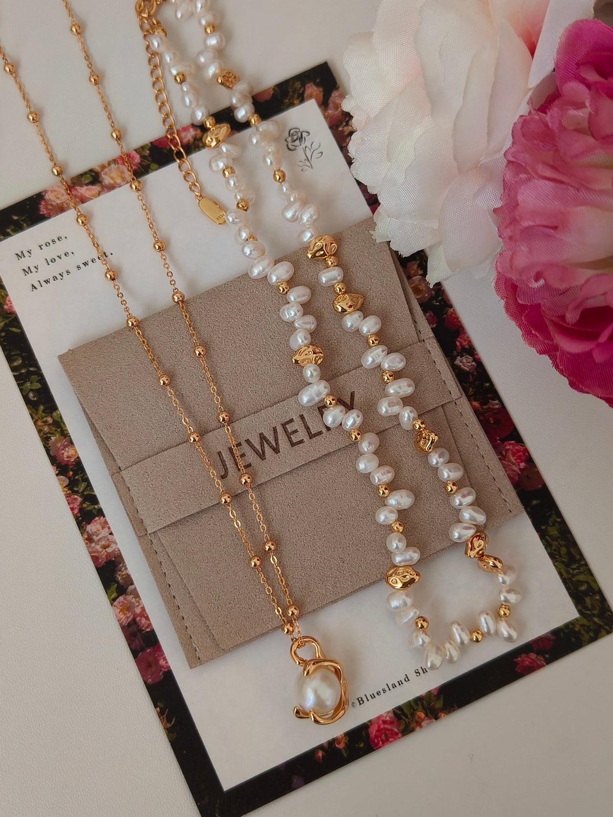 Pearl necklace set on display card with gold-tone chain and heart-shaped charm