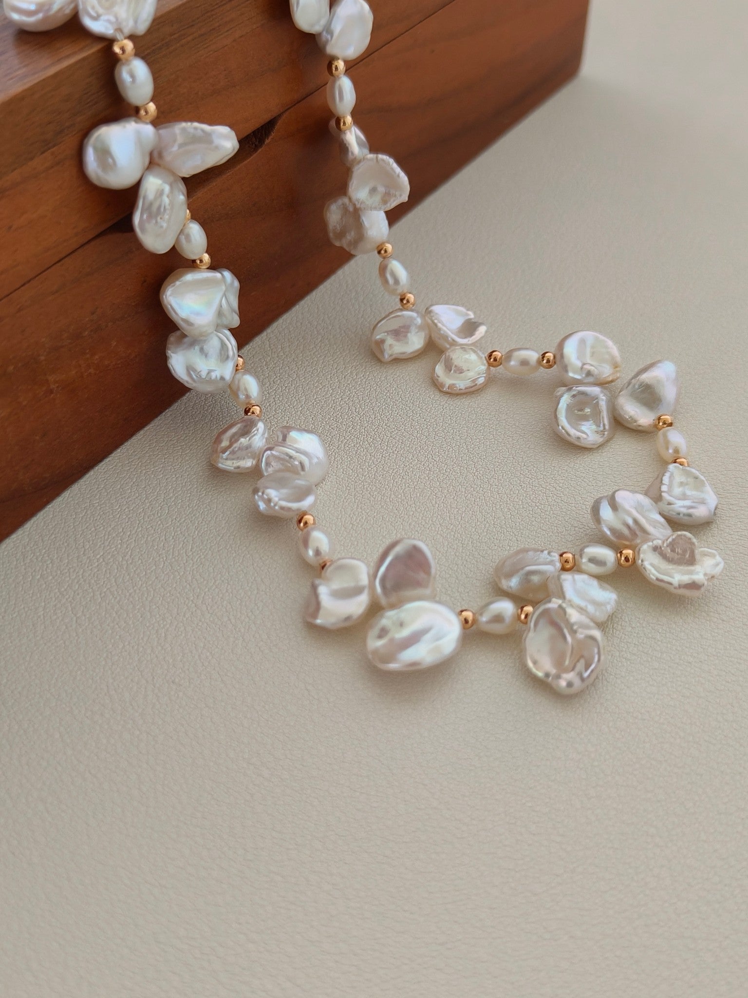 Freshwater pearl necklace with baroque pearl drops and gold bead spacers