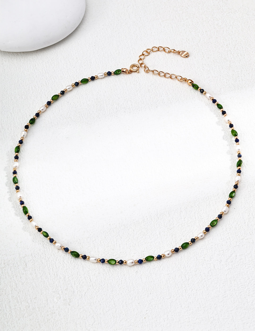 Bead pearl necklace featuring green and navy small beads on gold-tone chain