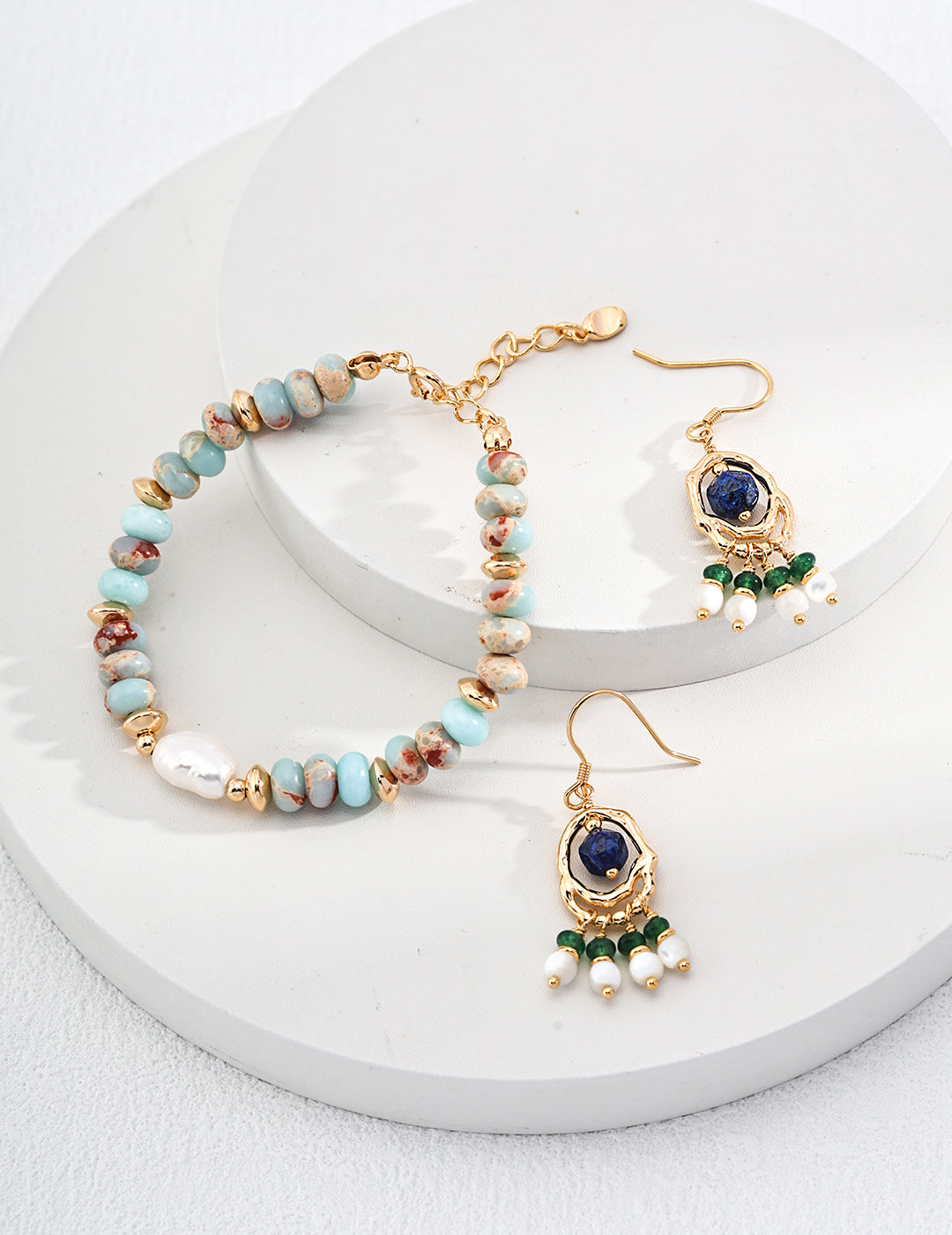 Gold-tone beaded bracelet with turquoise and multicolor stones, white pearl accent, and chain clasp