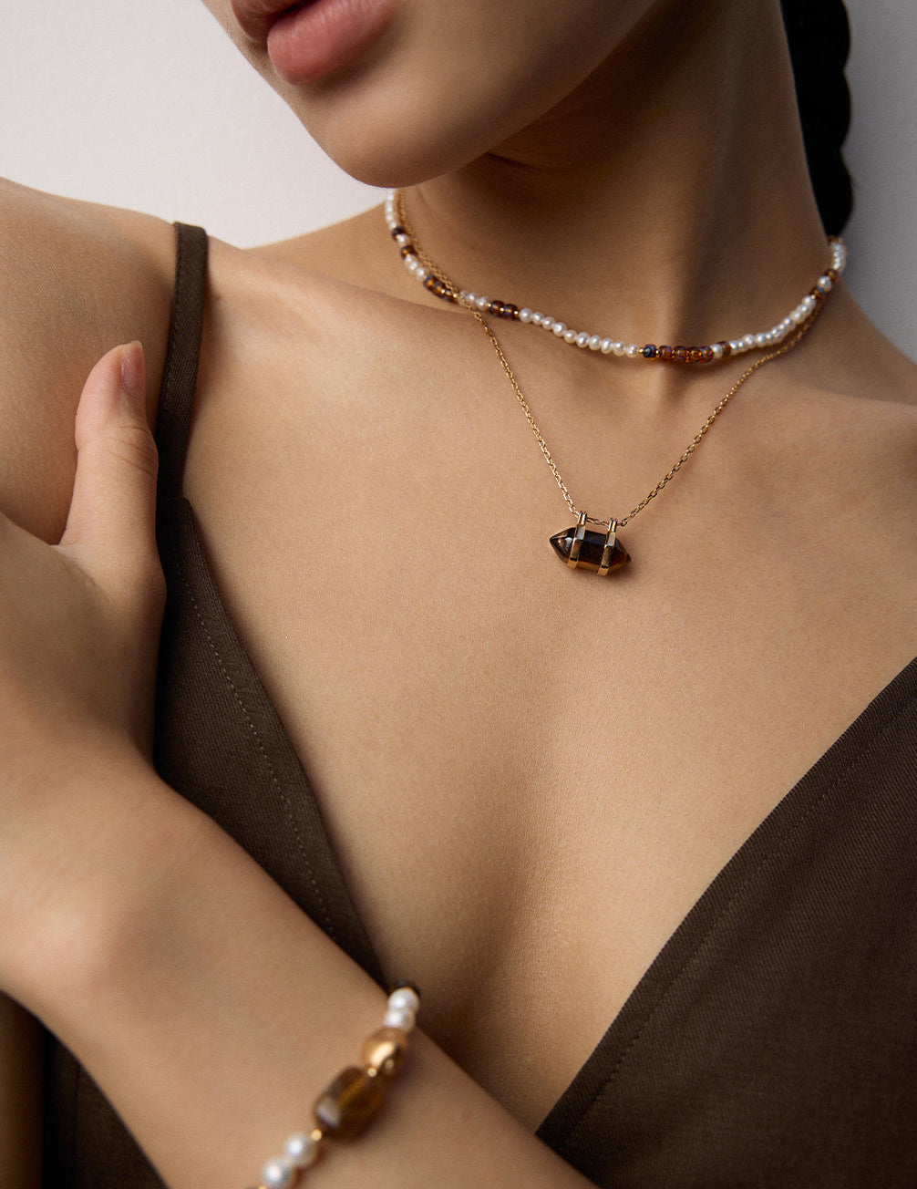 Pearl and amber bead necklace with gold chain and small brown bead segments