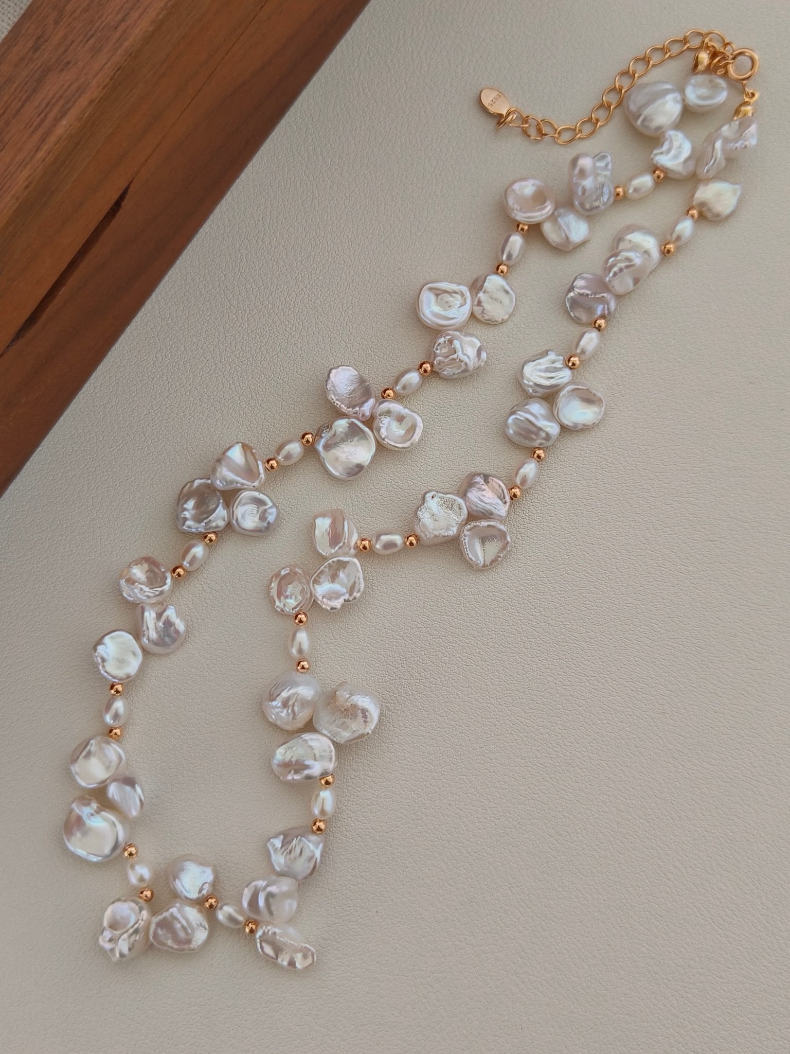 Freshwater pearl necklace angled view with gold chain and large baroque pearl flowers