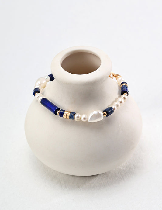 Freshwater pearl and lapis bead bracelet on a mannequin bust