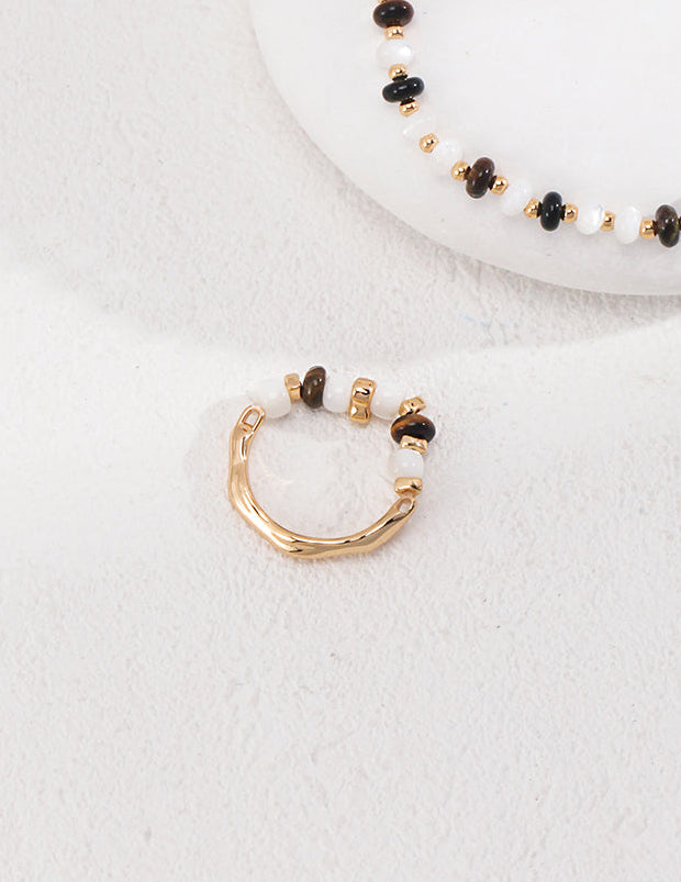 Gold-tone beaded hoop ring with white and dark bead segments
