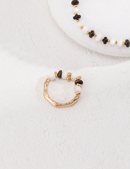 Gold-tone beaded hoop ring with white and dark bead segments