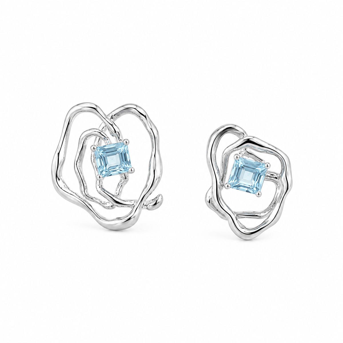 Asymmetrical silver-tone earrings with blue square gemstone and sculpted heart-like frames